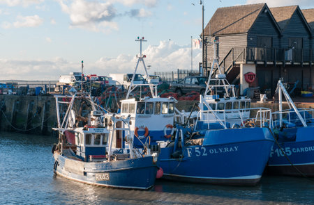 Fishing boats moored at Whitstable harbor in Kent Englandのeditorial素材