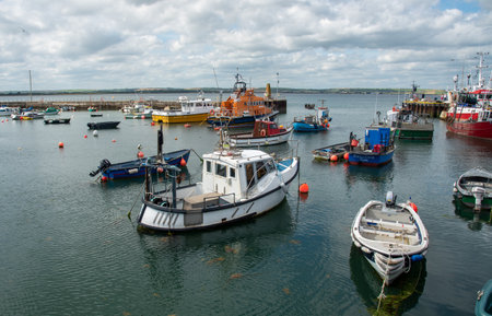 Fishing boats moored at Ballycotton fishing village marina Cork County Irelandのeditorial素材