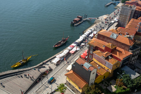View colourful houses at Rebiera the old town of Porto city and wooden wine boats at douro river in...