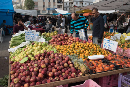 People buying groceries at a fruit and vegetable market in Nicosia Cyprusのeditorial素材