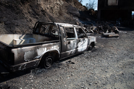 Destroyed burnt car and property after fireの写真素材