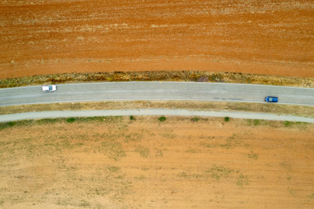 Top view of car driving on rural road.