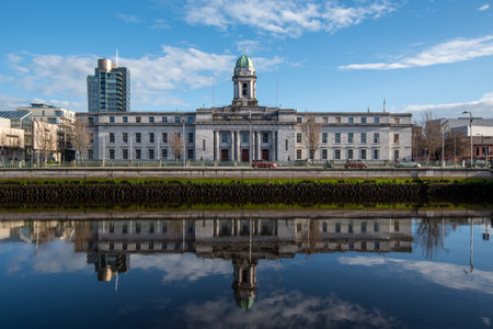 Cork city hall building reflected on river lee Ireland Europe