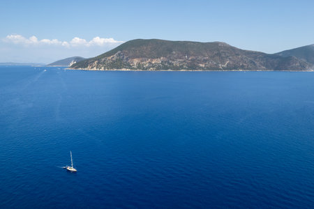 Drone scenery of a sail yacht sailing in the Ionian sea . Turquoise calm sea water. Summer holidays