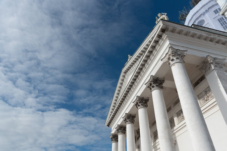 Low angle view of details of the neoclassical style architecture of the cathedral of Helsinki against cloudy skyの写真素材
