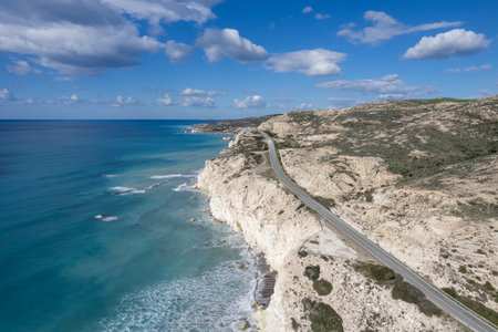 Scenic coastal road winding along turquoise mediterranean sea in cyprusの写真素材