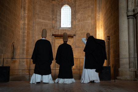 Sufi dervishes standing in bellapais abbey performing a ceremonyの写真素材