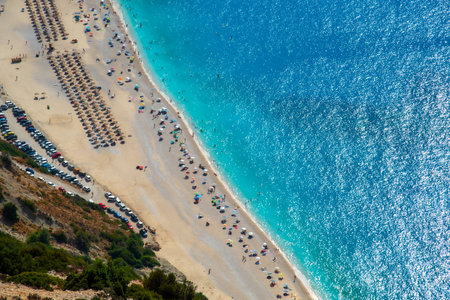 Tropical beach view with crystal clear water with tourist people on the shore. Myrtos famous beach Kefalonia Greeceの写真素材