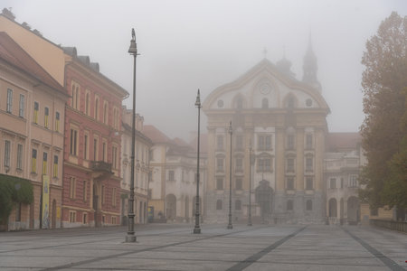 Fog enveloping congress square and ursuline church of the holy trinity in ljubljanaの写真素材