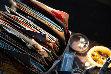 Old vinyl records with worn paper covers stacked together. Vintage music, at flea market