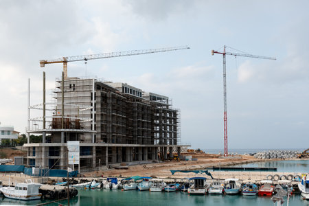 Paralimni, cyprus, February 4 2024: Coastal building construction site with multiple tower cranes...