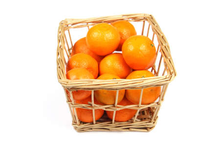 Wicker box with mandarins on whiteの写真素材