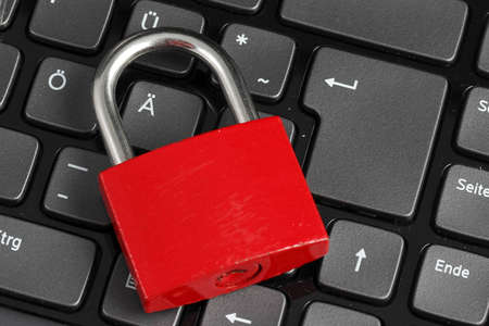 Padlock on black computer keyboardの写真素材
