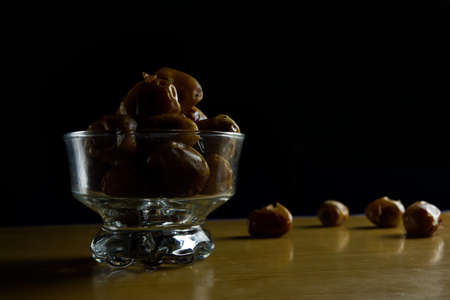 a sweet date dish set in a white glass on a black backgroundの写真素材