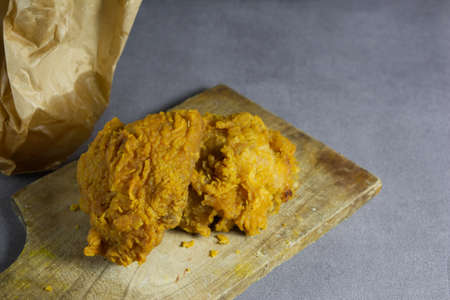 2 pieces of delicious fried chicken on board and fake cementの写真素材