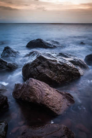 Rocks and flowing waves along the shoreline of Camiguin Island