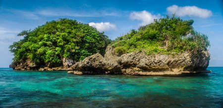 Scenic view of rock islands over crystal clear sea water.の写真素材