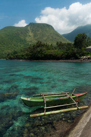 Scenic view of a fishing boat on a clear sea waterの写真素材