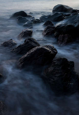Rocks and flowing waves along the shoreline of Camiguin Islandの写真素材