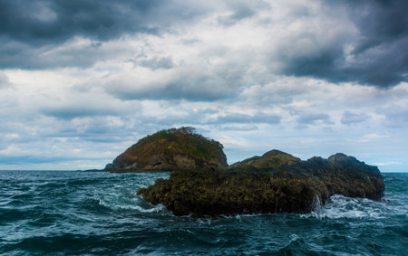 Rock Island over scenic blue sea water.の写真素材