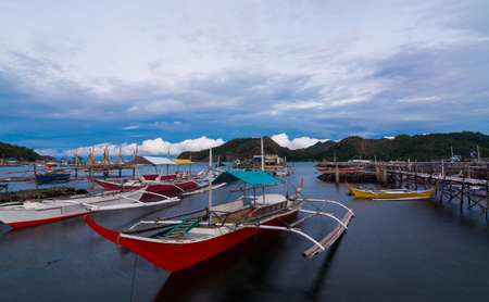 Scenic view of fishing boats near the beachの写真素材
