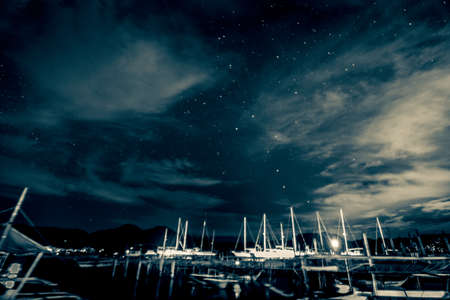 Yachts on the beach under the starry skyの写真素材
