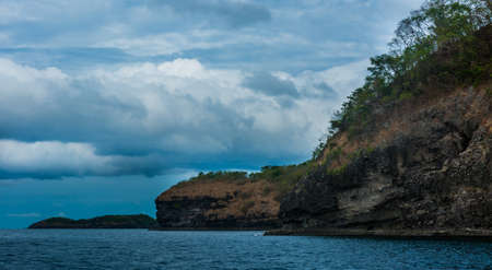 Rock Island over scenic blue sea waterの写真素材