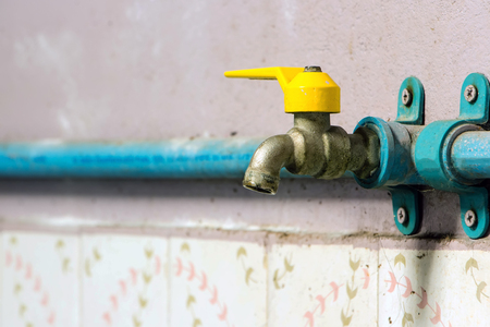 Corrode brass faucet is turned off. Connect with blue plumbing in the bathroom.
