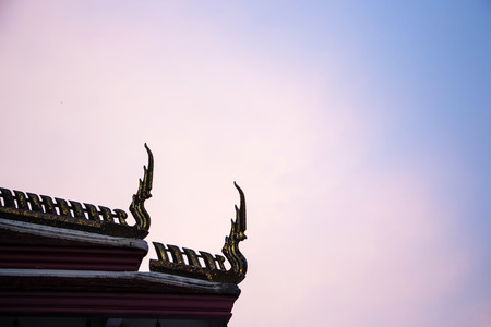 Thai temple roof with sky background in the evening.の写真素材