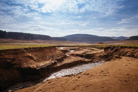 The bottom of the empty Studena dam near Pernik, Bulgaria. Hot weather and climate changes makes the dam almost empty. Climate disaster.の写真素材