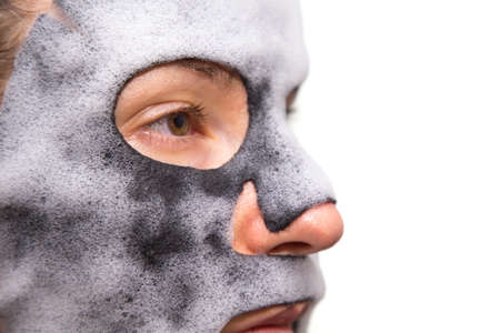 Isolated girl with cleansing mask on the face.の写真素材