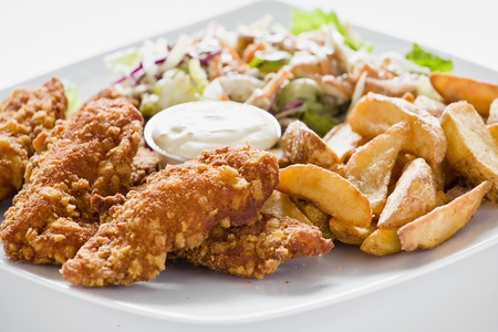 Photograph of Tasty meal with Chicken Nuggets Potatoes and Saladの写真素材