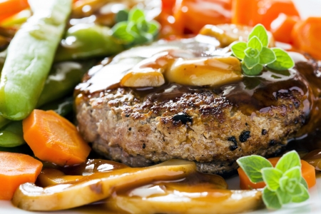 Photograph of a tasty dish of burger and vegetablesの写真素材