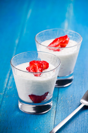 Close up of two glasses of yogurt and strawberriesの写真素材