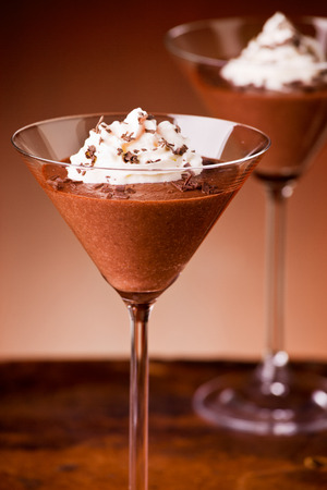 Chocolate mousse dessert in glasses with whipped creamの写真素材
