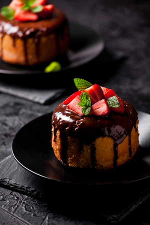 Close up of a vanilla and chocolate cake with strawberriesの写真素材