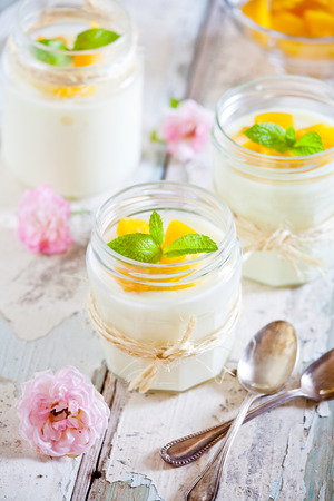 Jars of homemade vanilla pudding with rose extractの写真素材