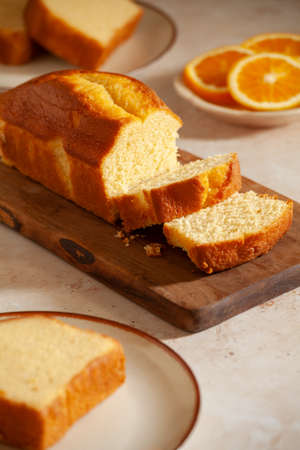 Slices of homemade cake with oragnic orangesの写真素材