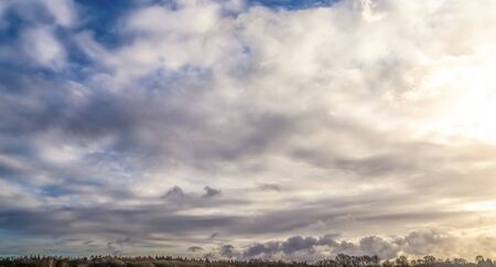 Beautiful mixed cumulus and cirrus clouds on a blue sky in summerの写真素材