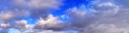 Beautiful panorama of orange and yellow cloudscapes at sunrise/sunset  on a blue sky in high...