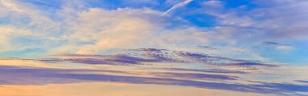 Beautiful stunning sunset clouds panorama in orange and red colors