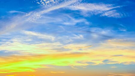 Beautiful stunning sunset clouds panorama in orange and red colorsの写真素材