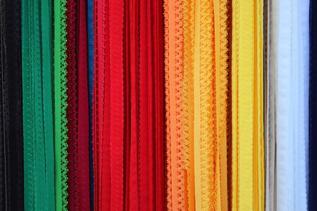 Close up view on colorful hanging and folded fabric textures and textiles in high resolution found on a fabrics marketの写真素材