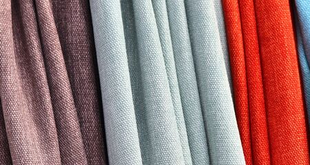 Close up view on colorful hanging and folded fabric textures and textiles in high resolution found...