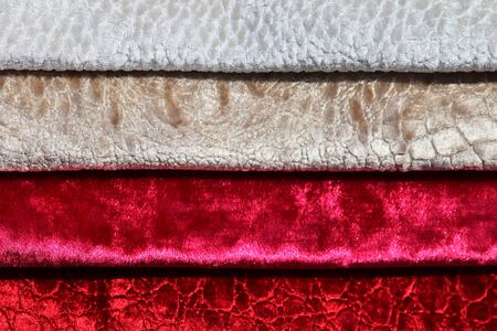 Close up view on colorful hanging and folded fabric textures and textiles in high resolution found...