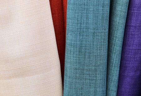 Close up view on colorful hanging and folded fabric textures and textiles in high resolution found...