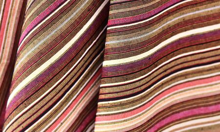 Close up view on colorful hanging and folded fabric textures and textiles in high resolution found...