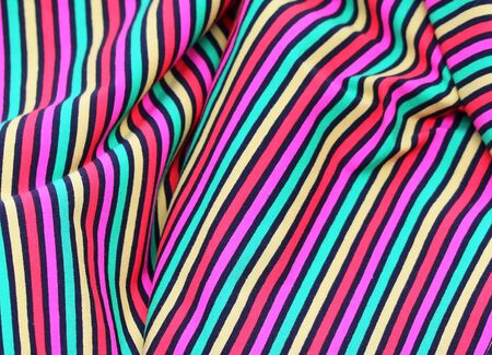 Close up view on colorful hanging and folded fabric textures and textiles in high resolution found...