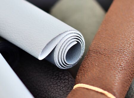 Close up view on colorful hanging and folded fabric textures and textiles in high resolution found on a fabrics marketの写真素材