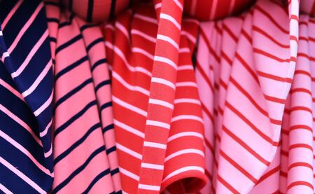 Close up view on colorful hanging and folded fabric textures and textiles in high resolution found...
